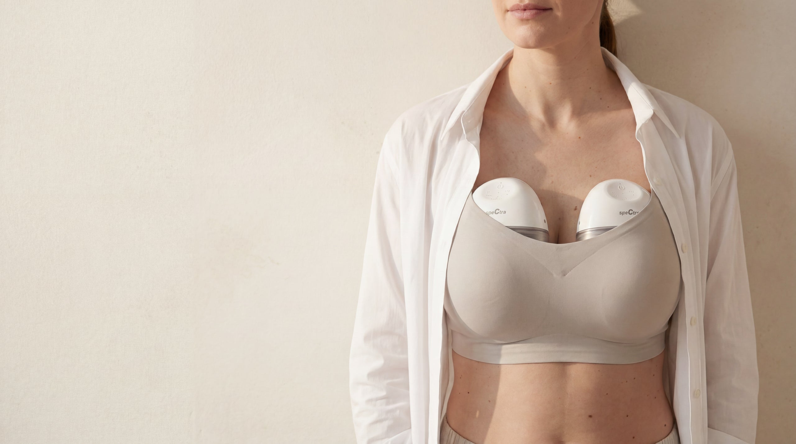 Mum double pumping hands-free with two Spectra Wearable breast pumps