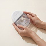 Hands holding the Spectra Wearable pump cup